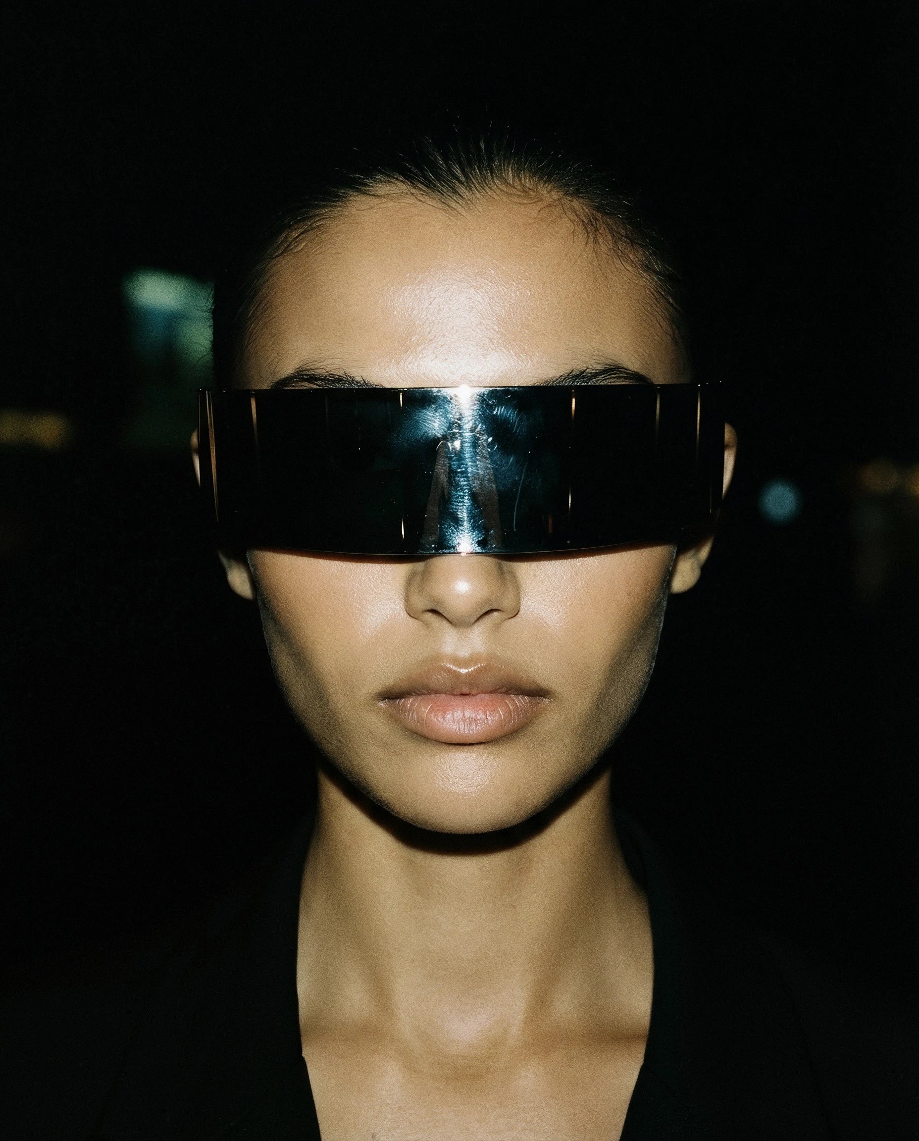 GRECALE — mirrored silver shield sunglasses on model, night flash portrait