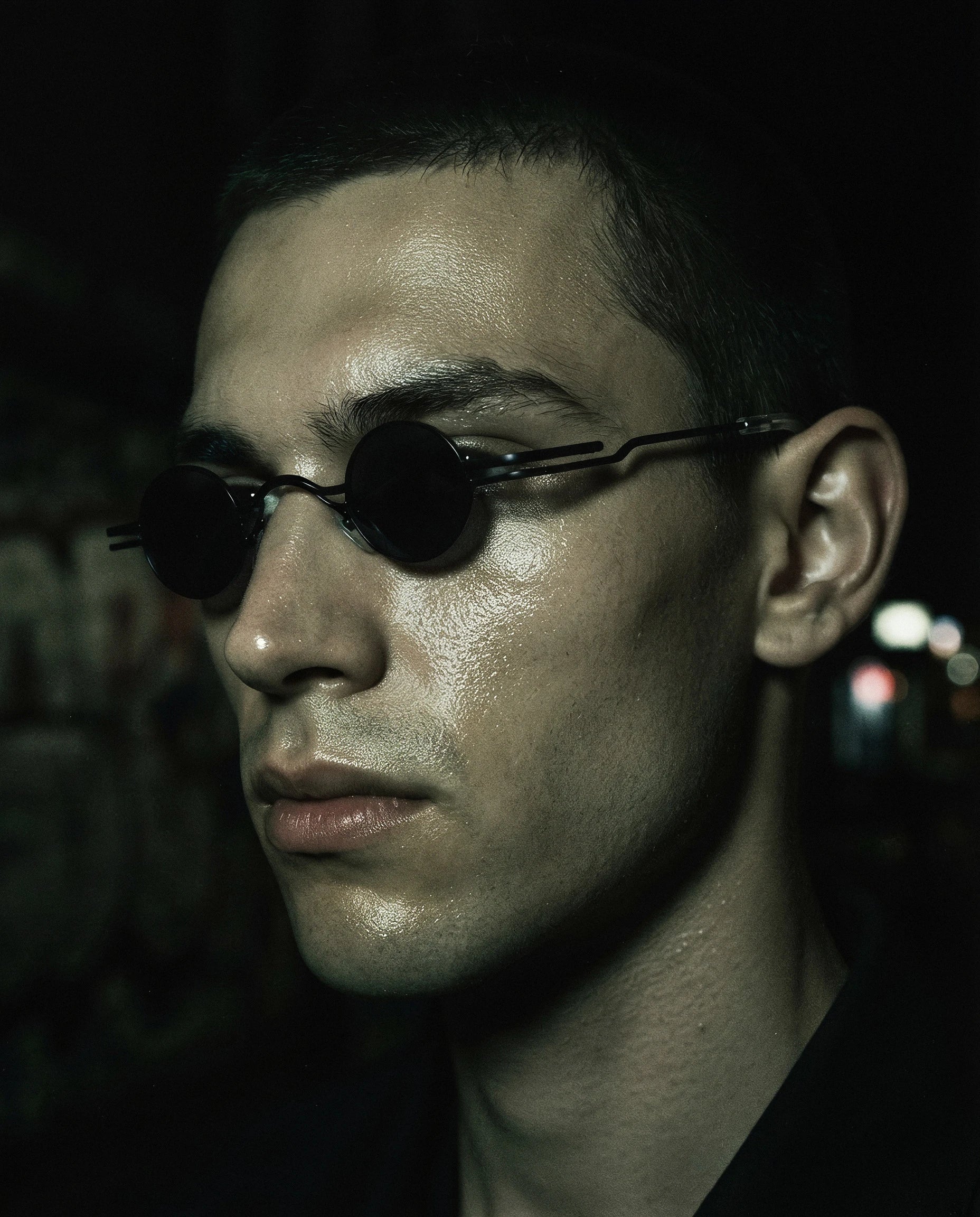 LIBECCIO — micro round metal sunglasses on model, night flash portrait — angle view