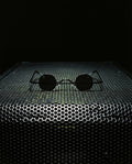 LIBECCIO — micro round sunglasses still life on speaker grille at night