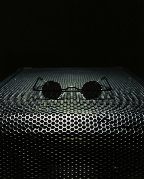 LIBECCIO — micro round sunglasses still life on speaker grille at night