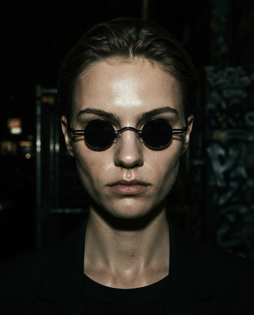 LIBECCIO — micro round metal sunglasses on model, night flash portrait