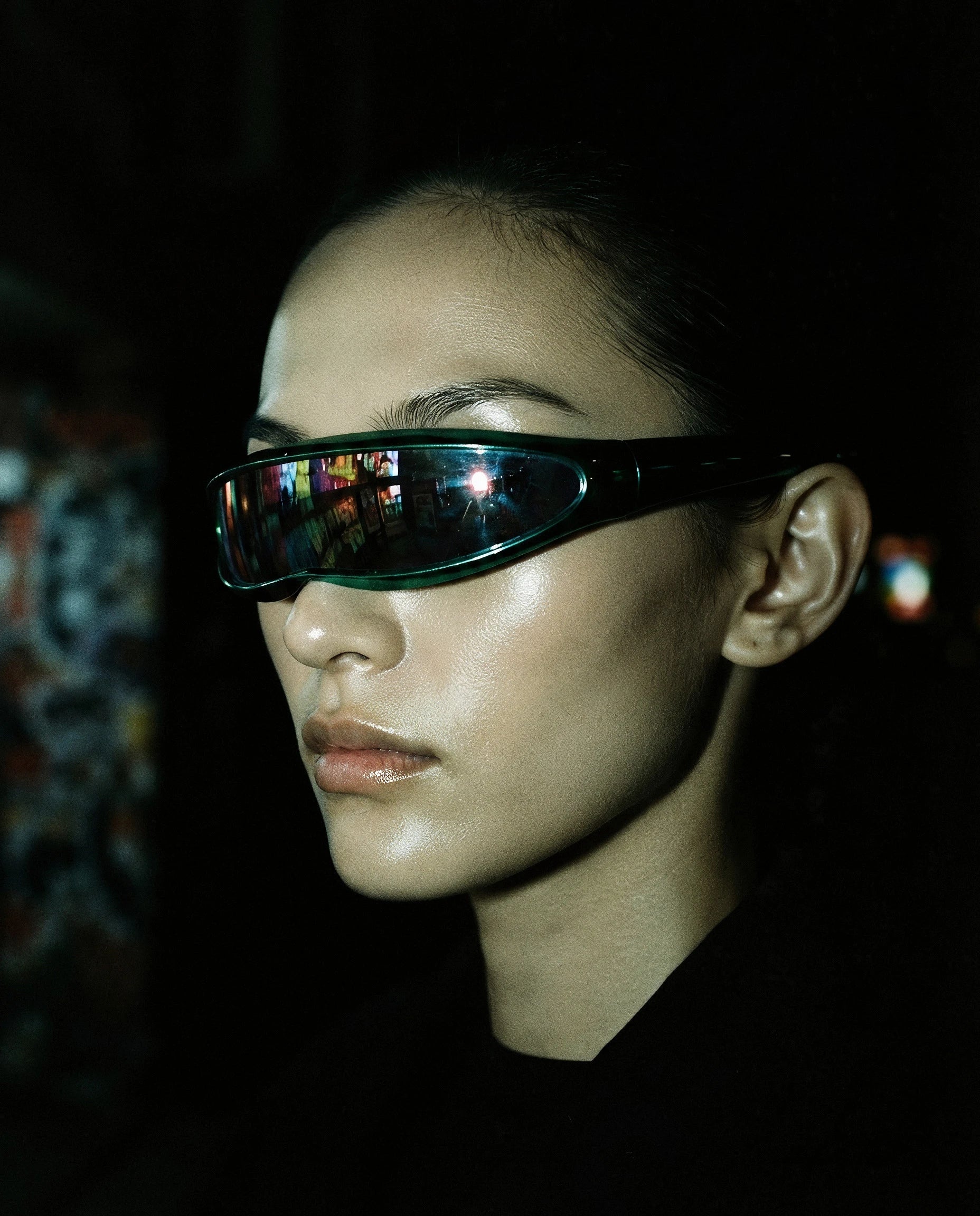 MAESTRALE — metallic green shield visor sunglasses on model, night flash portrait — angle view