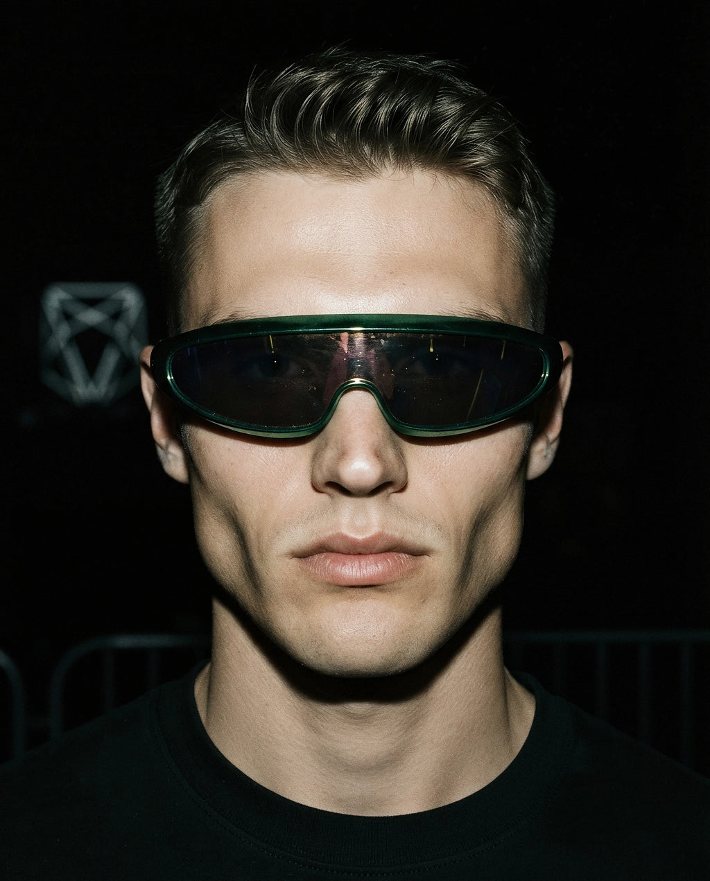 MAESTRALE — metallic green shield visor sunglasses on model, night flash portrait