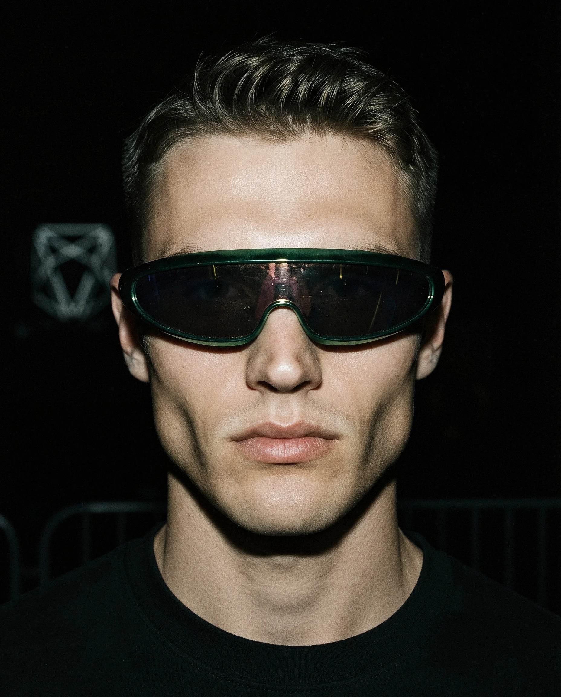 MAESTRALE — metallic green shield visor sunglasses on model, night flash portrait