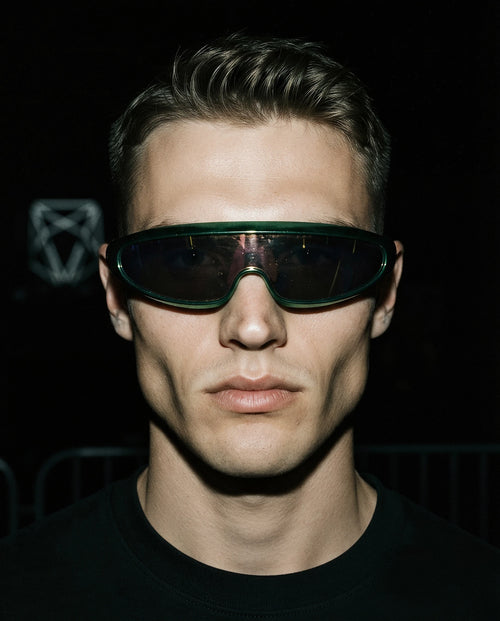 MAESTRALE — metallic green shield visor sunglasses on model, night flash portrait