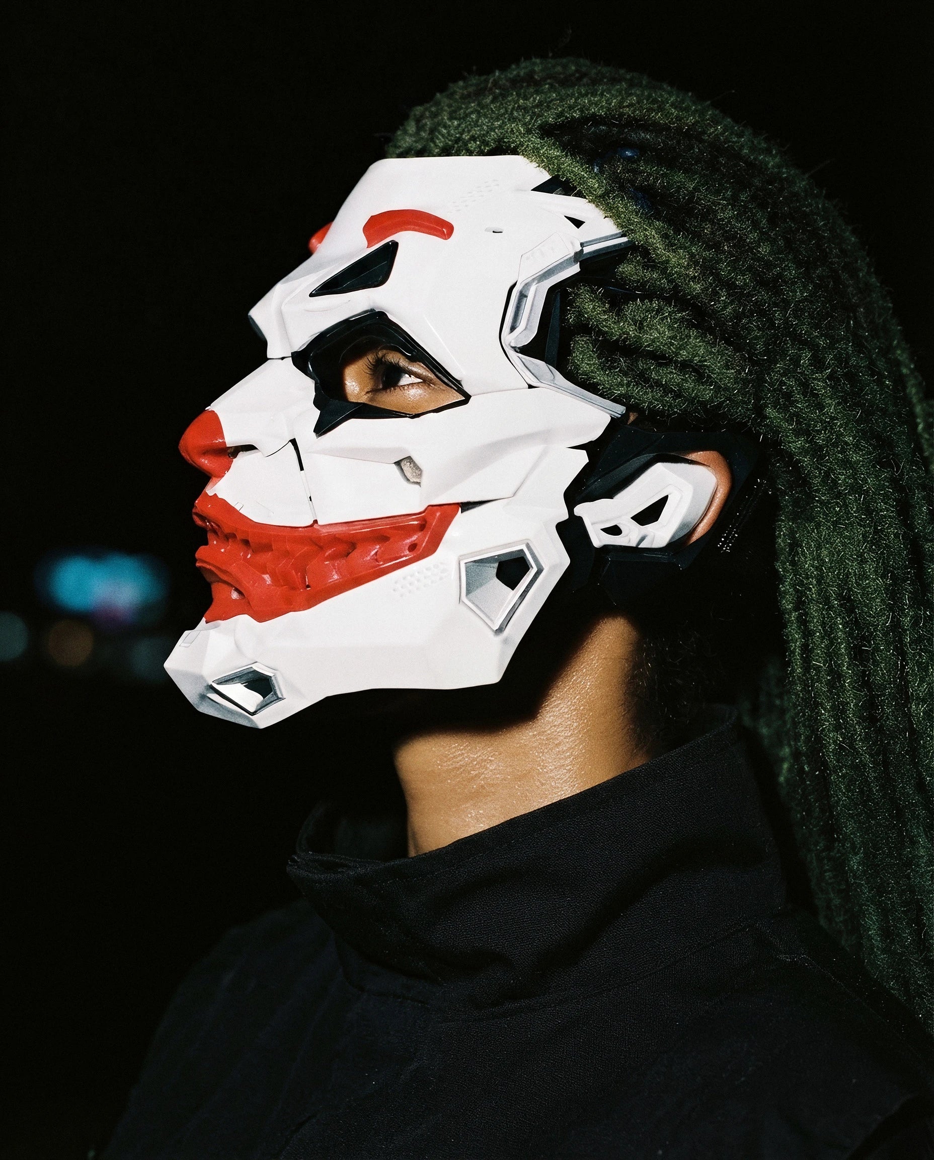 MEZZANOTTE — white and red armored cyberpunk mask on model, night flash portrait — angle view