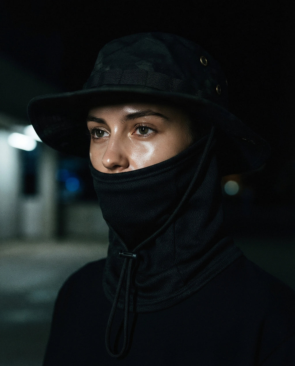NOTTURNO — black boonie hat with balaclava on model, night flash portrait — angle view