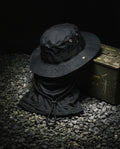 NOTTURNO — black boonie hat and balaclava set still life on gravel