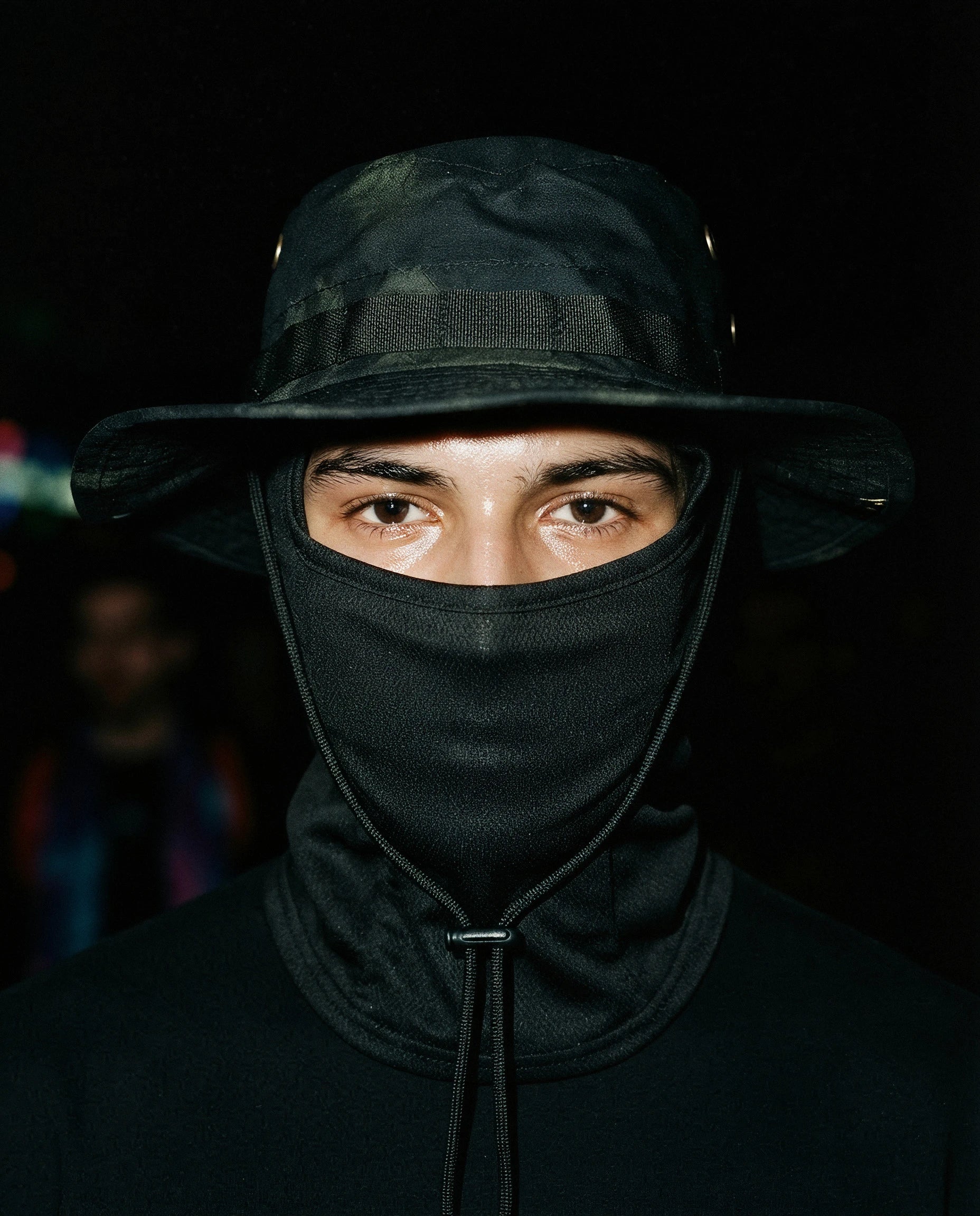 NOTTURNO — black boonie hat with balaclava on model, night flash portrait