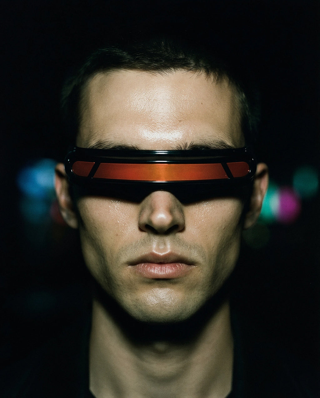 PONENTE — black single-band visor sunglasses with red lens strip on model, night flash portrait